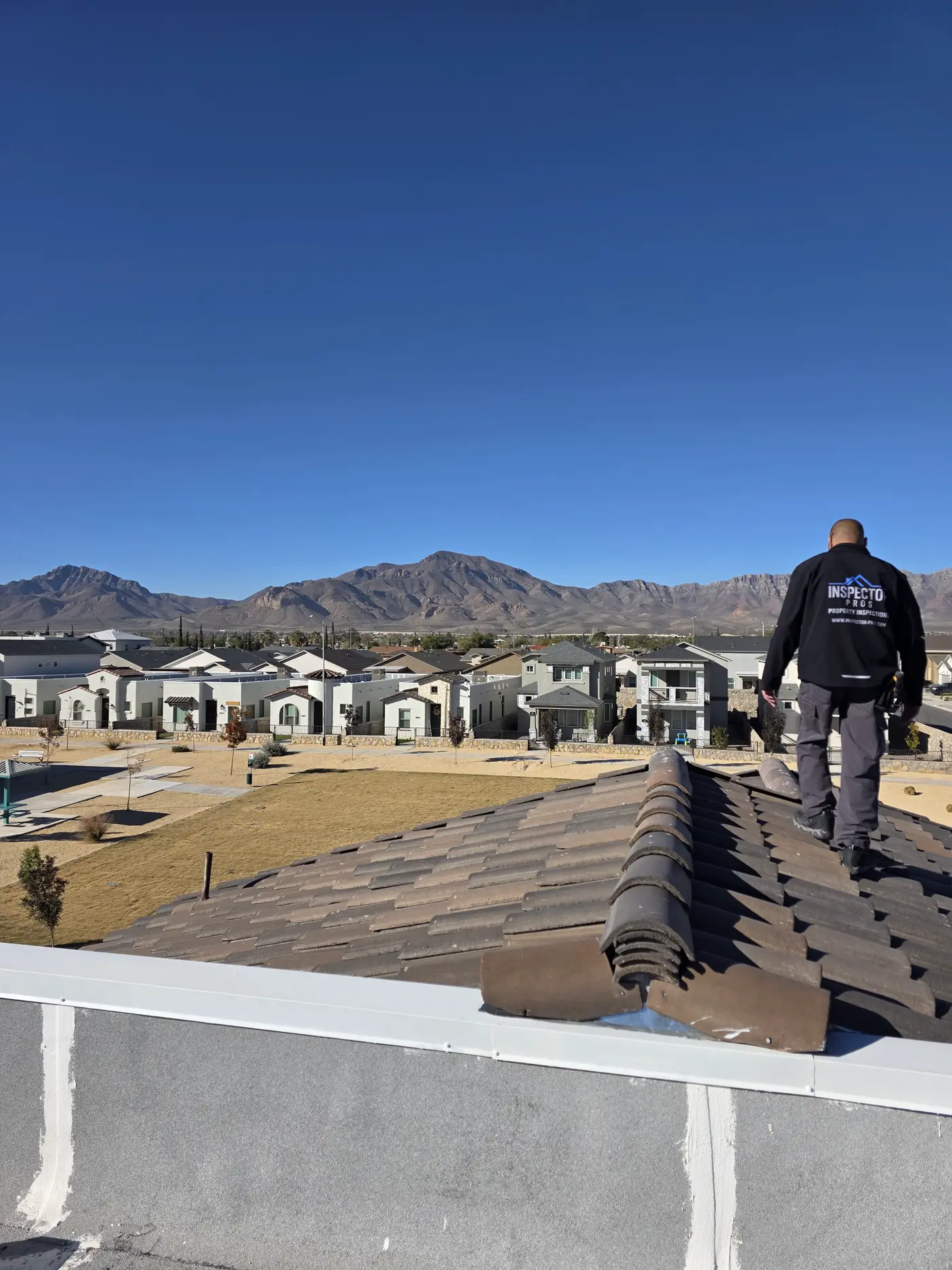 Inspector Pros inspector walking a tile roof during an El Paso home inspection